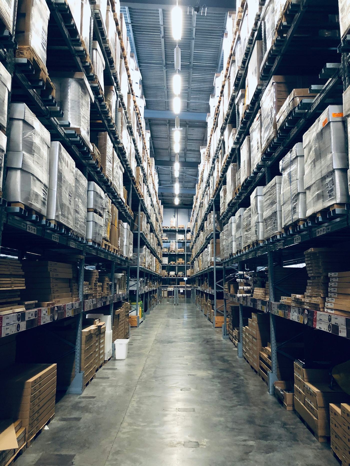 Racked warehouse aisle receding into the distance