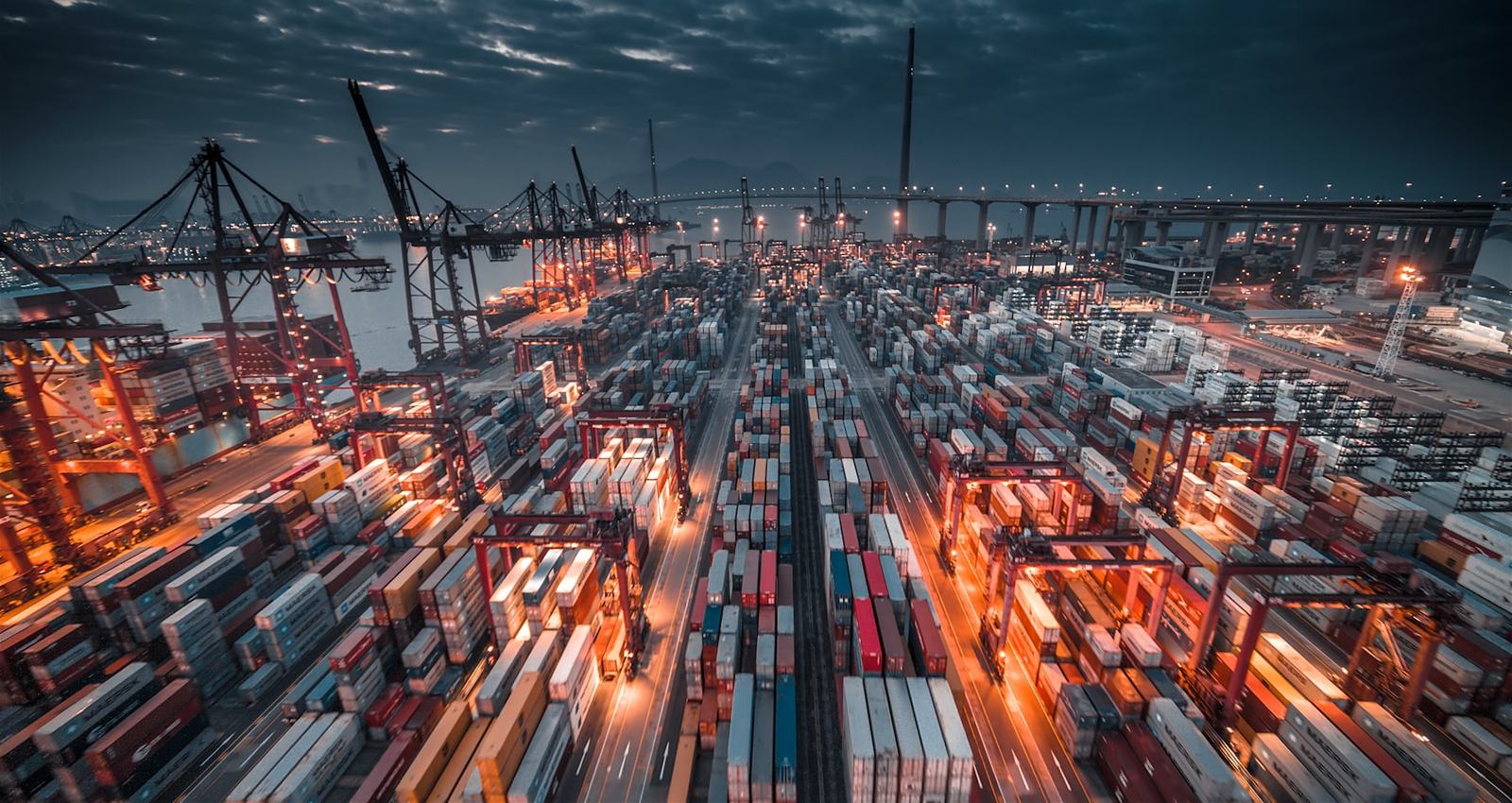 Container terminal yard lit at dusk